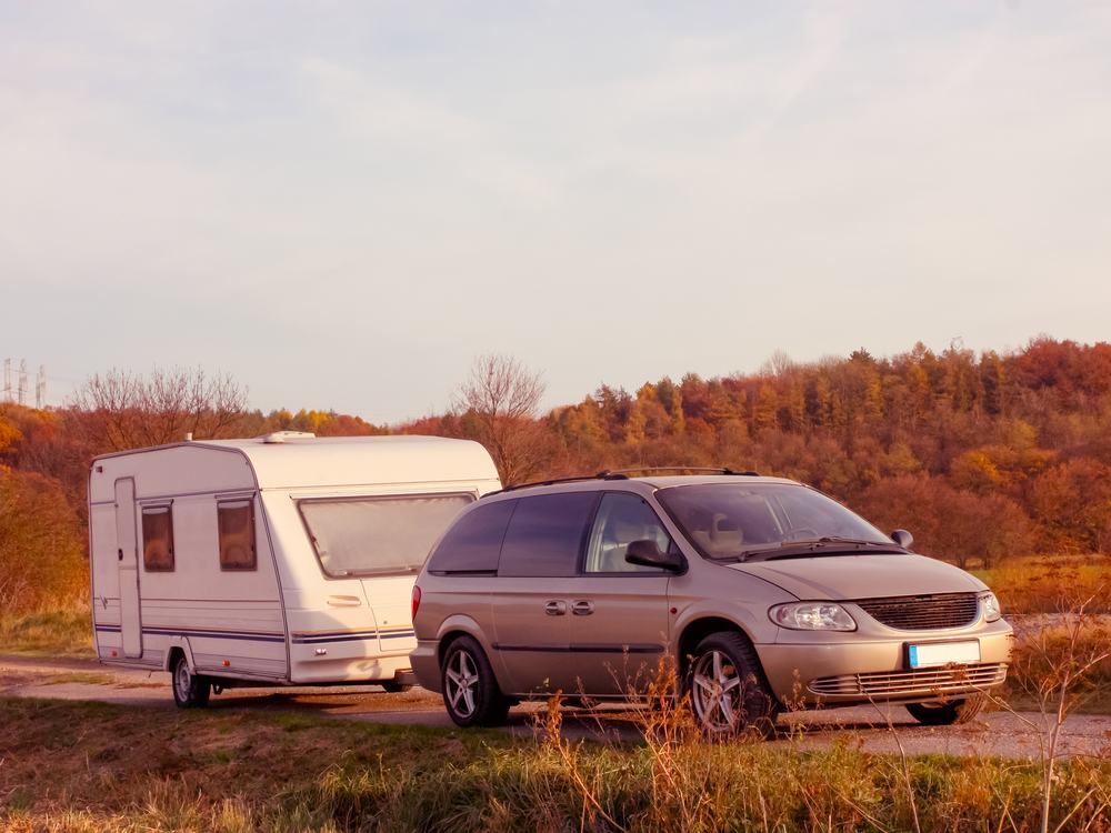 Touring caravan being towed on a country lane